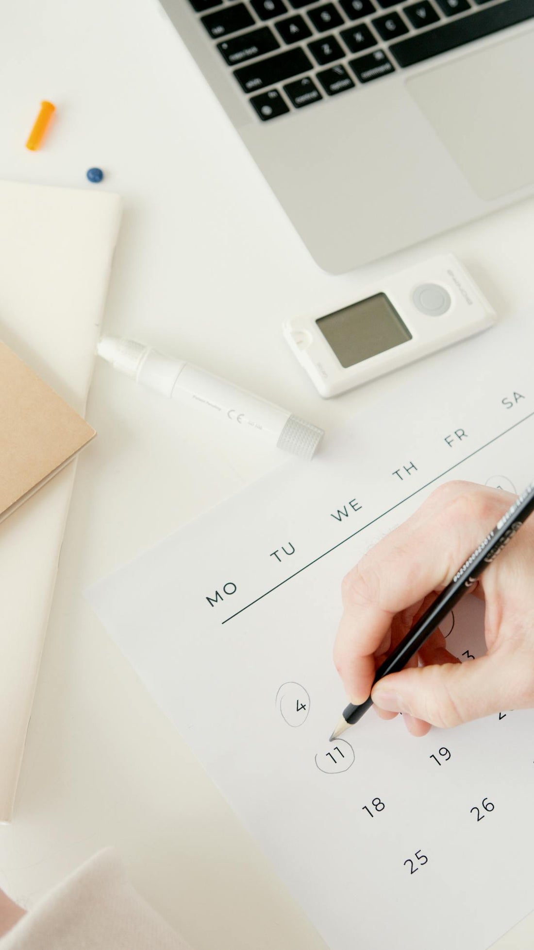 Person scheduling treatment sessions on a calendar for HBOT planning